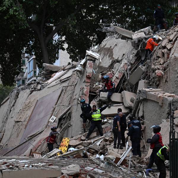 Rescue workers search for survivors of a massive earthquake in Venezuela