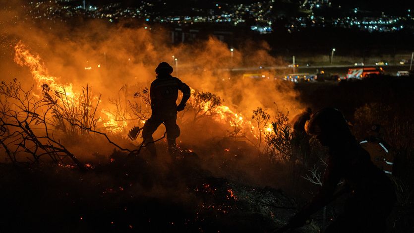 Rescuers fight a January fire in Colombia.