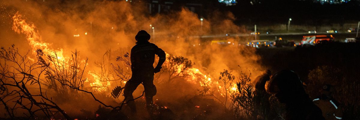 Rescuers fight a January fire in Colombia.
