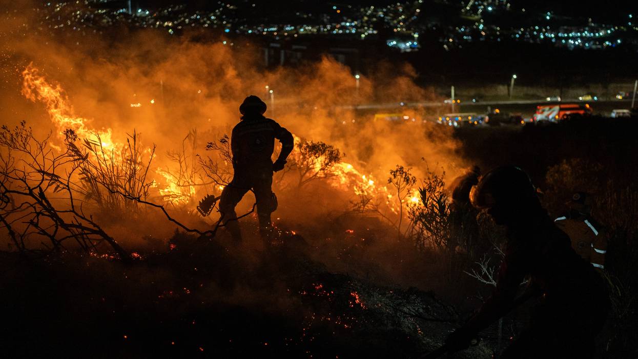 Rescuers fight a January fire in Colombia.