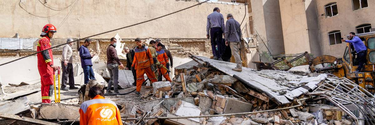 Rescuers search through bombing rubble in Tehran.