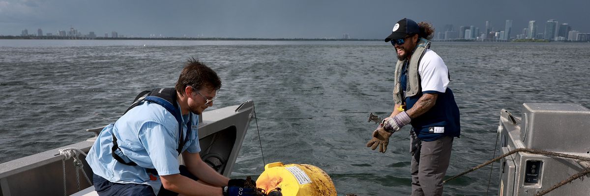 Researchers conduct routine maintenance on a research buoy