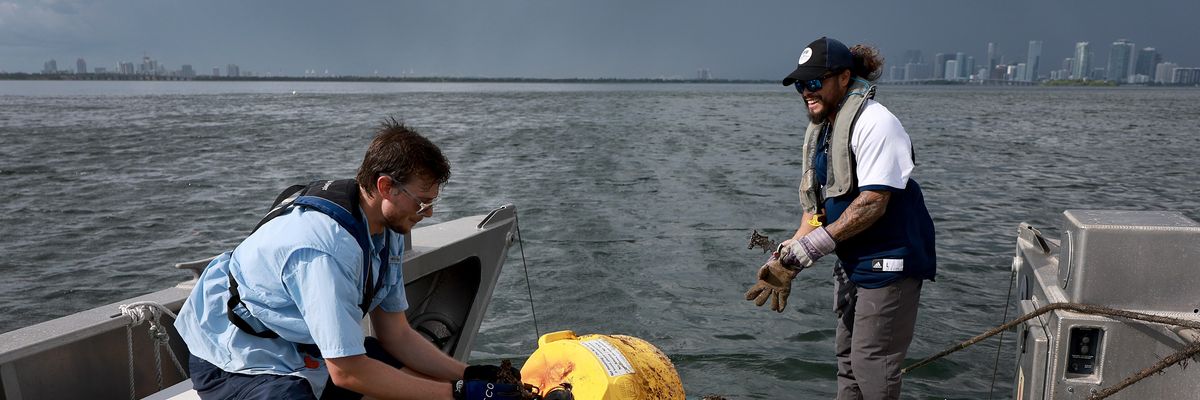 Researchers conduct routine maintenance on a research buoy