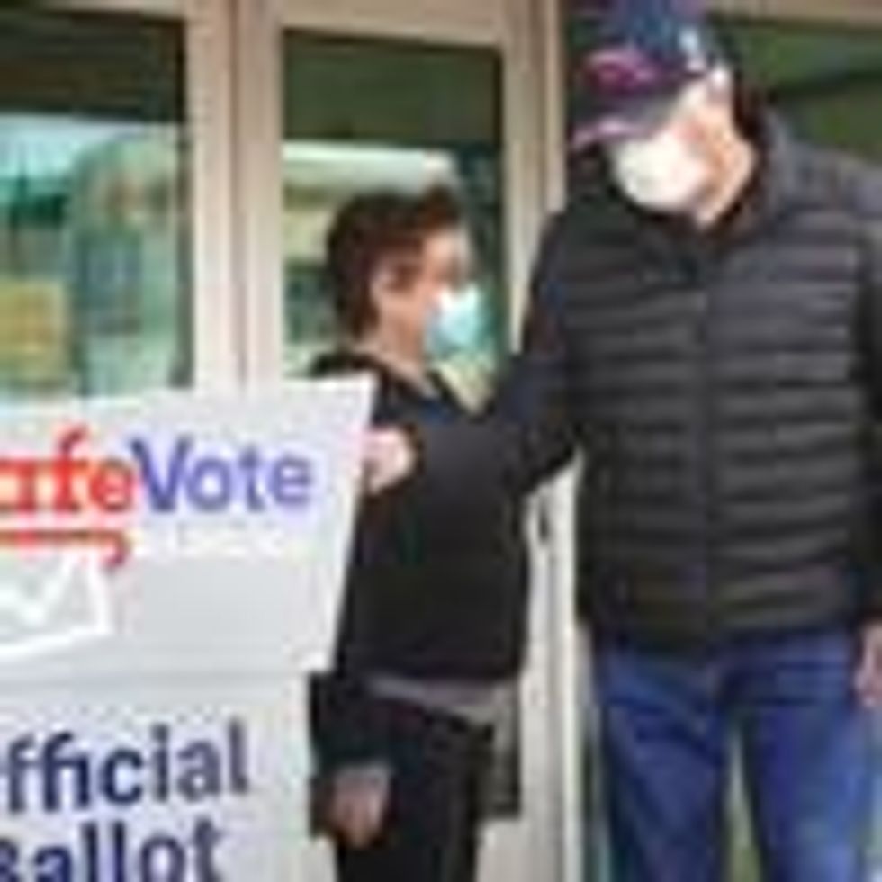 Residents drop mail-in ballots in an official ballot box outside of the Tippecanoe branch library on October 20, 2020 in Milwaukee