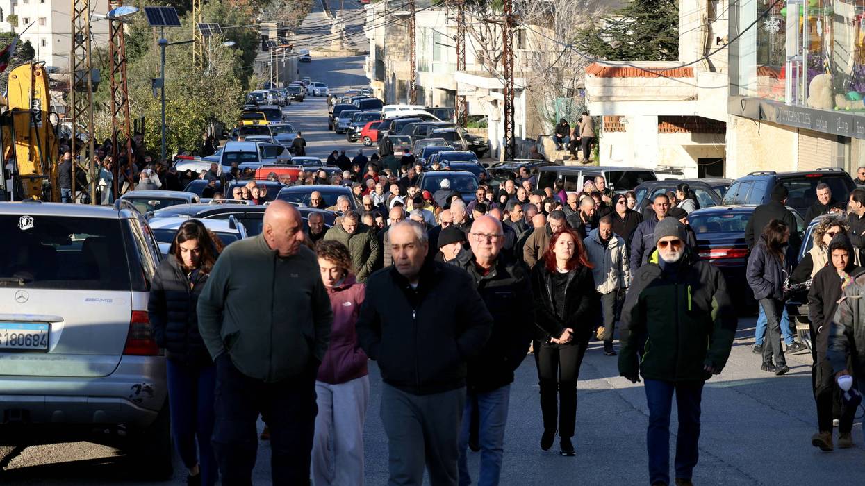 Residents in Al-Qlayaa, Lebanon march toward the municipality hall to show their anger over the killing of the town's pastor