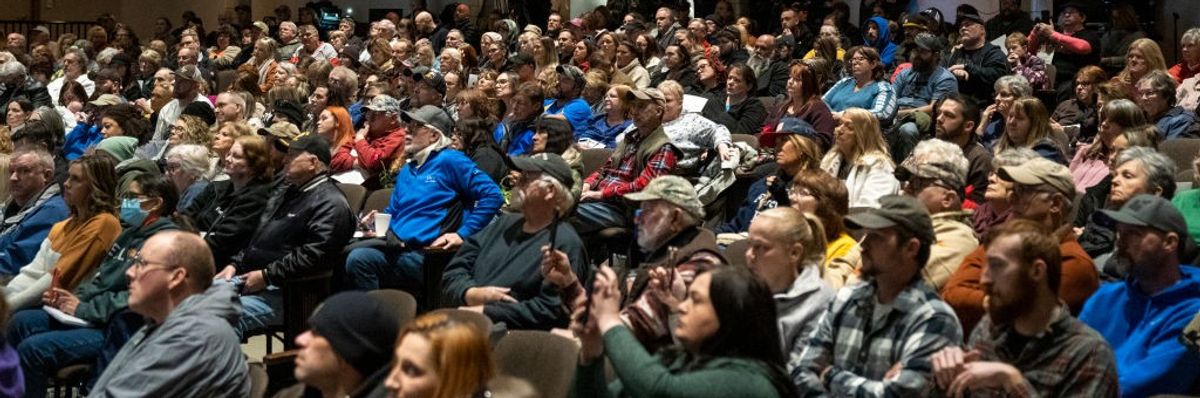 Residents listen as environmental activist Erin Brockovich speaks during a town hall at East Palestine High School on February 24, 2023 in East Palestine, Ohio.