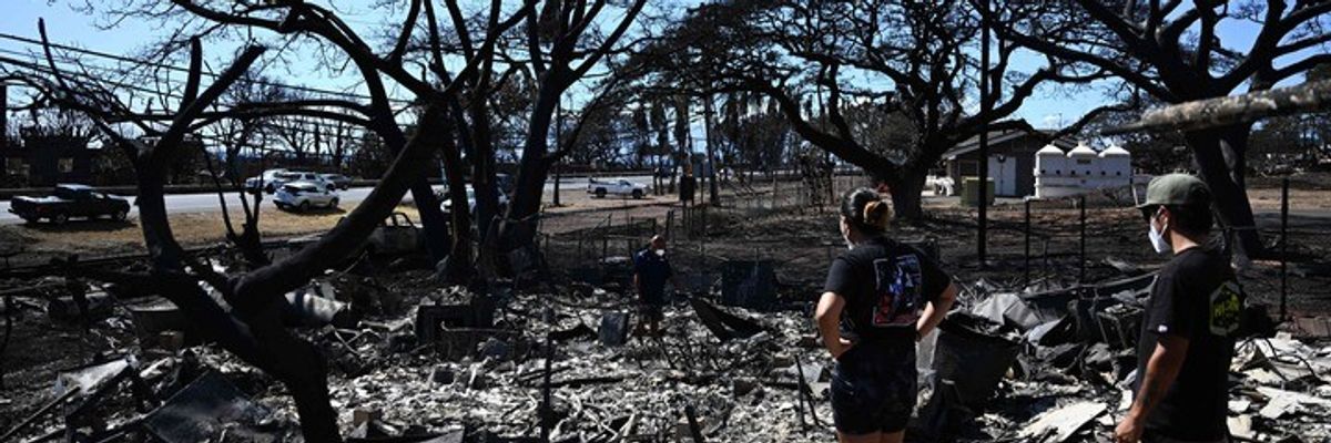 Residents look through burned home after Lahaina wildfire.