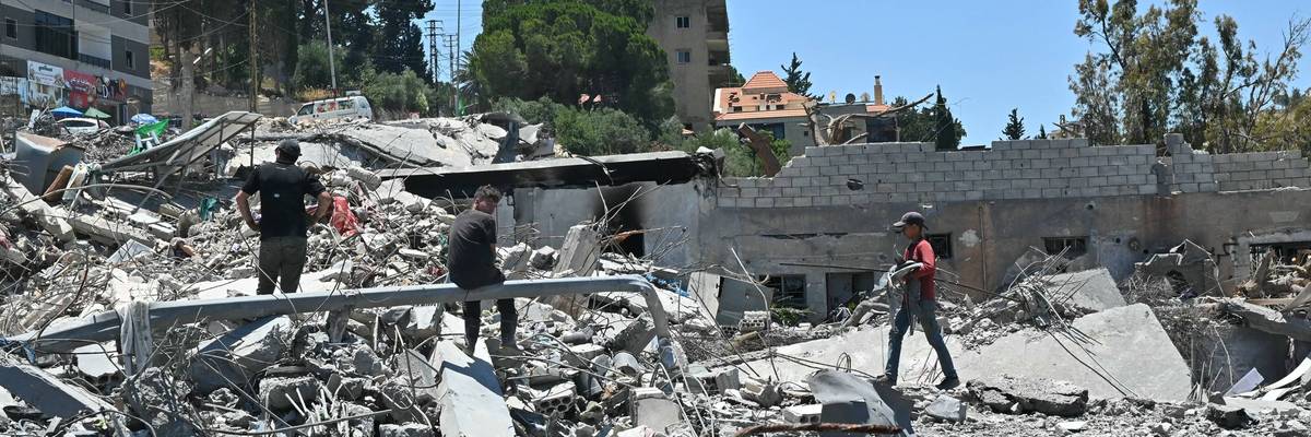 Residents look through the rubble of their homes in Lebanon.
