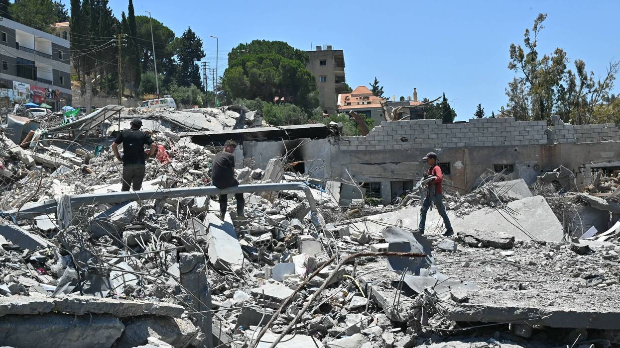 Residents look through the rubble of their homes in Lebanon.
