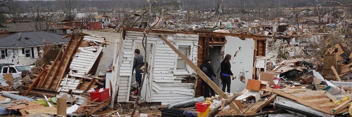 Residents search among the debris of a home after it was destroyed from Friday's tornado on December 15, 2021 in Dawson Springs, Kentucky.