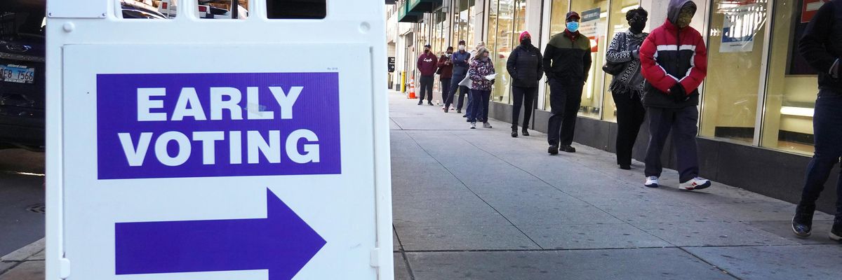 Residents wait in line to vote at an early voting site