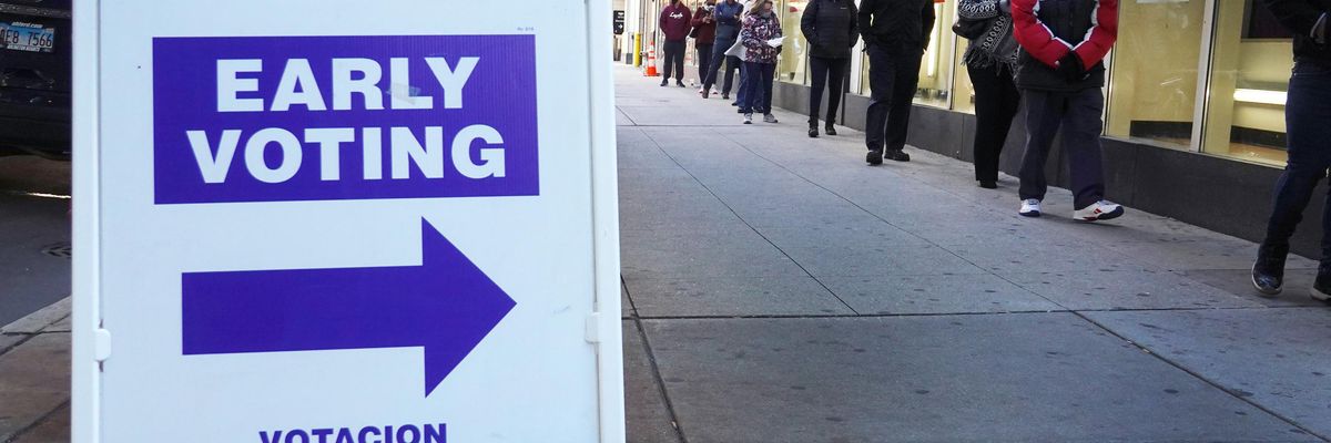Residents wait in line to vote at an early voting site
