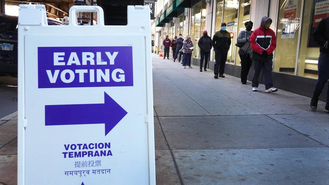 Residents wait in line to vote at an early voting site