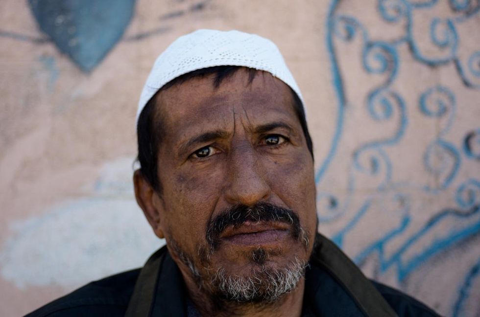 Retired fisherman Khaled Rajab Abu Riyal, 50, says he avoided the sea for nine years because of a liver disease he blames on the pollution he had to wade through as a fisherman. Photo by Kaamil Ahmed/Mongabay.