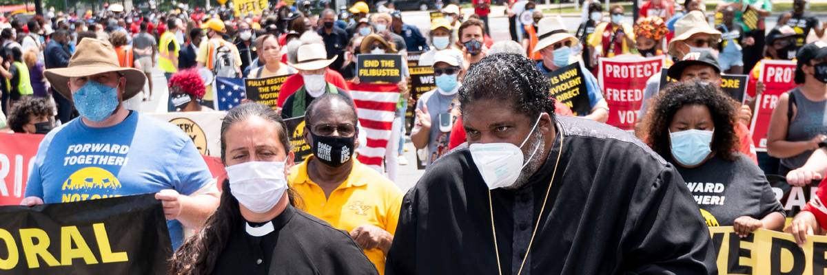 Rev. Dr. William J. Barber and Rev. Dr. Liz Theoharis lead a march in Washington, D.C.