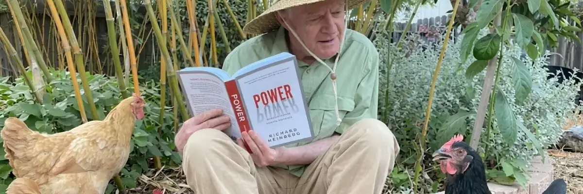Richard Heinberg reads to a chicken.