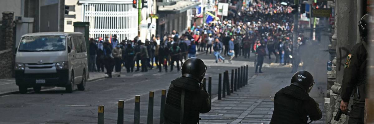 Riot police fire tear gas at Bolivian protesters.