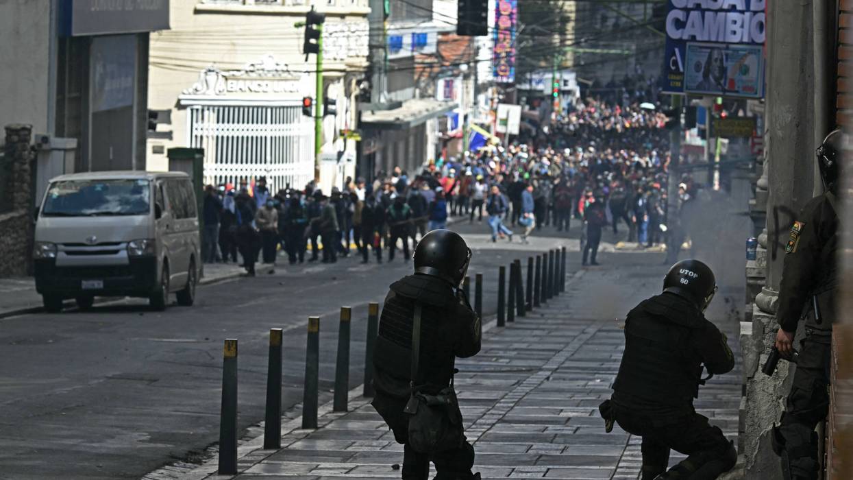 Riot police fire tear gas at Bolivian protesters.