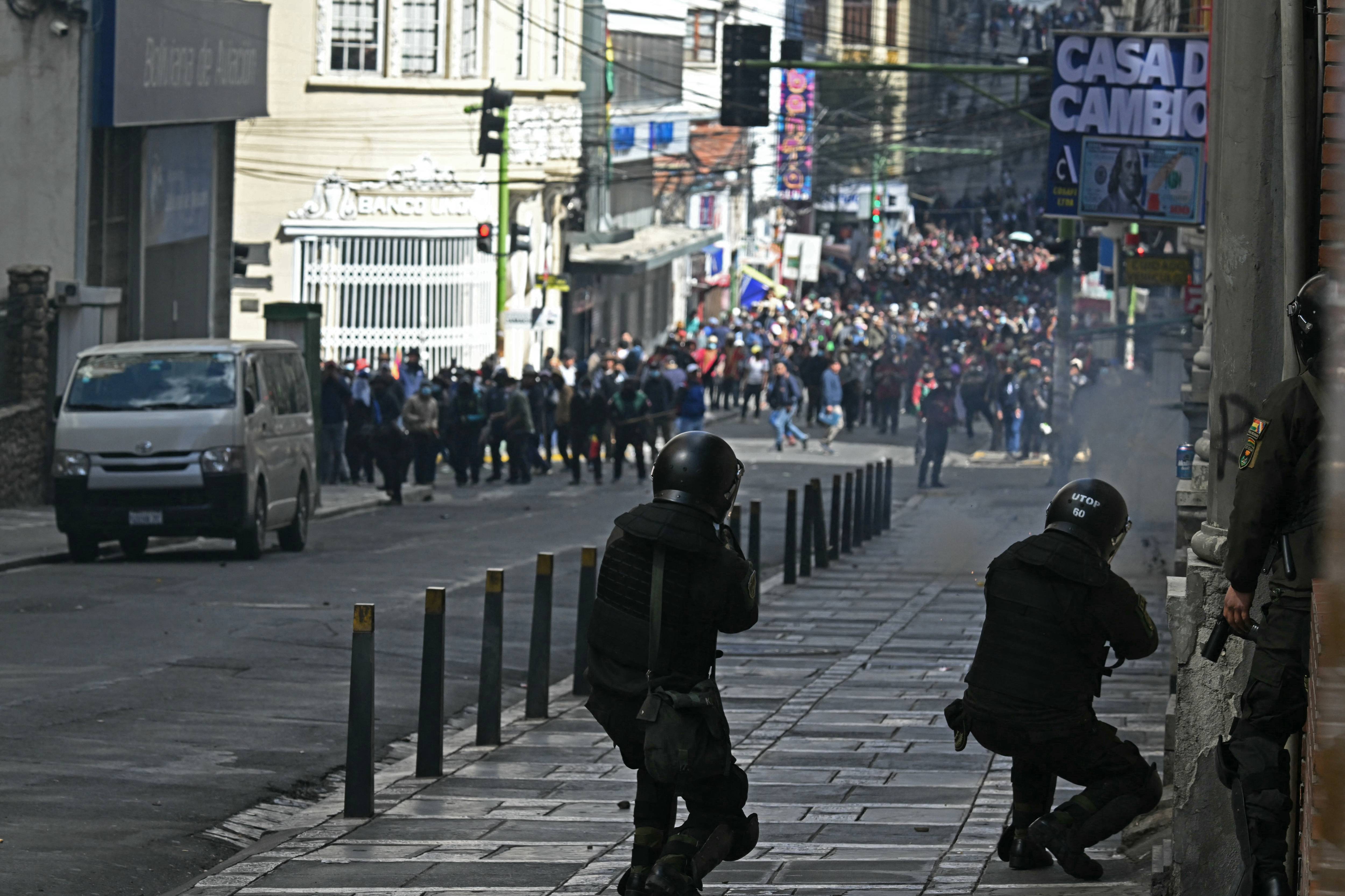 Riot police fire tear gas at Bolivian protesters.