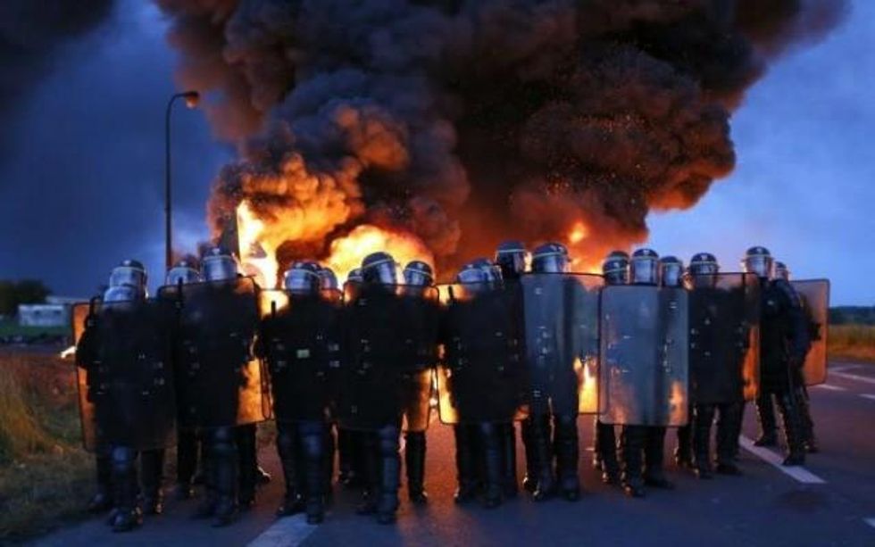 Riot police moved in on workers blockading an oil depot in Douchy-les-Mines, northern France. (Photo: Thibault Vandermersch/EPA)