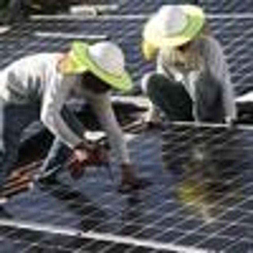 Roger Garbey and Andres Hernandez, from the Goldin Solar company, install a solar panel system on the roof of a home on January 23, 2018 in Palmetto Bay, Florida. (Photo: Joe Raedle via Getty Images)