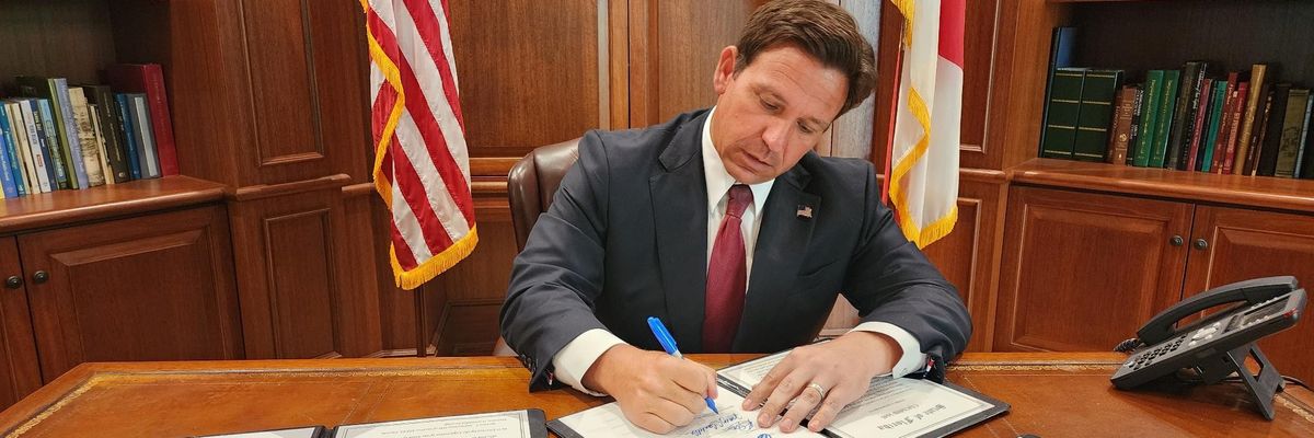 Ron DeSantis signs a bill.