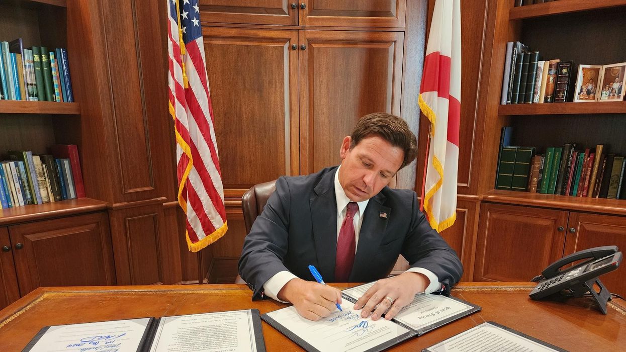 Ron DeSantis signs a bill.