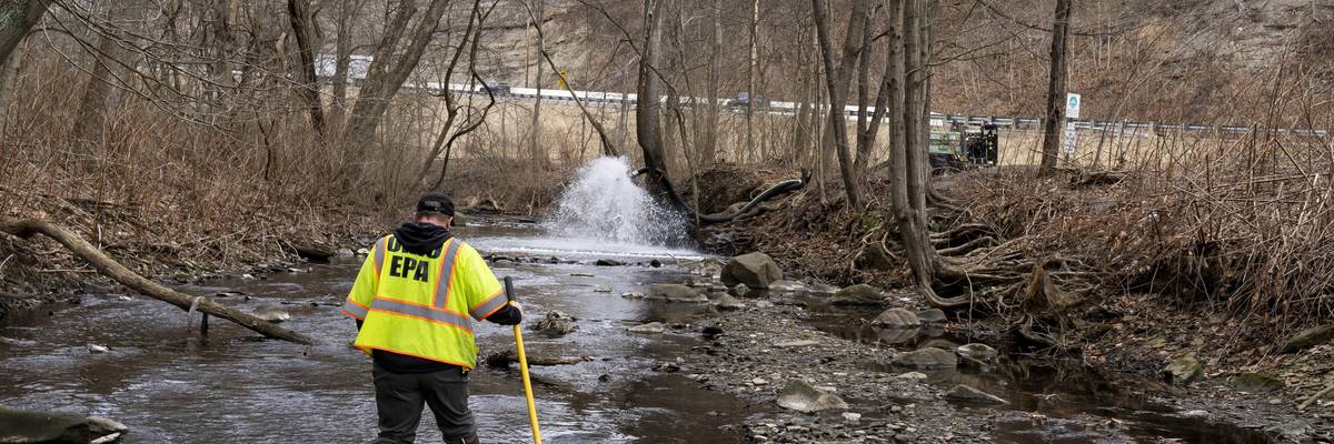 Ron Fodo of the Ohio Environmental Protection Agency examines a creek following a Norfolk Southern train derailment in East Palestine on February 20, 2023.