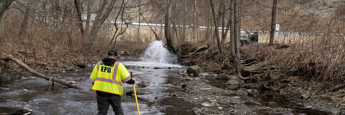 Ron Fodo of the Ohio Environmental Protection Agency examines a creek following a Norfolk Southern train derailment in East Palestine on February 20, 2023.