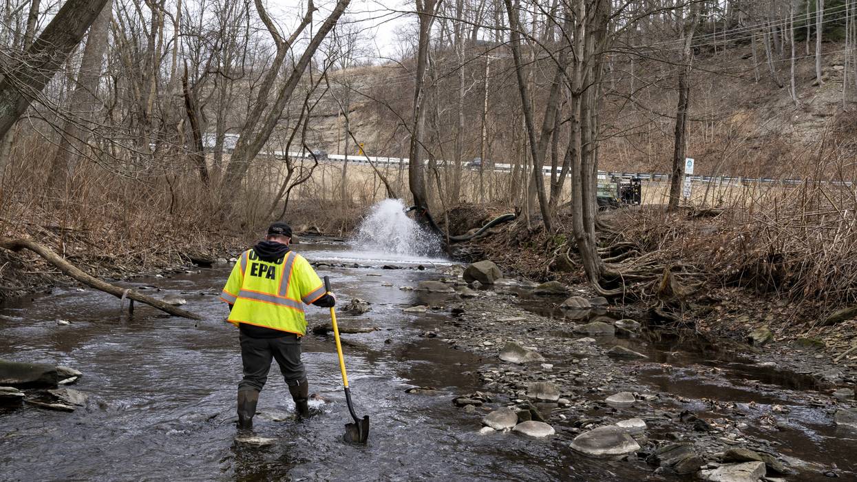 Ron Fodo of the Ohio Environmental Protection Agency examines a creek following a Norfolk Southern train derailment in East Palestine on February 20, 2023.