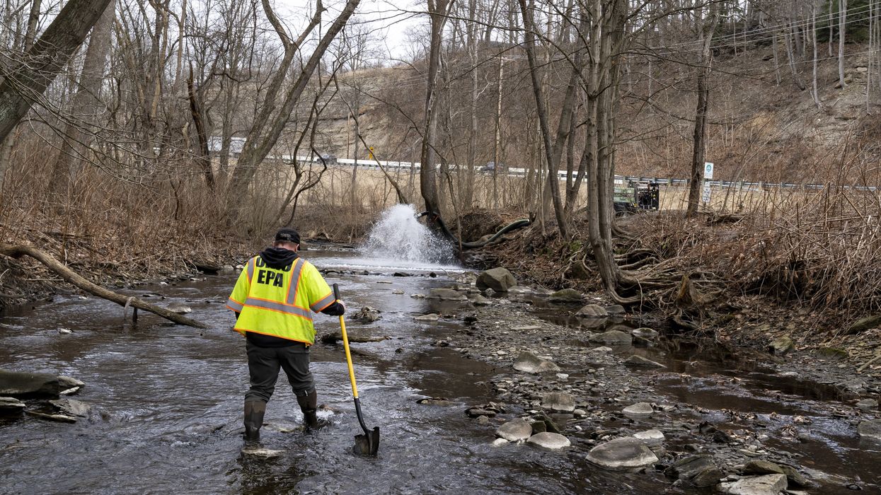 Ron Fodo of the Ohio Environmental Protection Agency examines a creek following a Norfolk Southern train derailment in East Palestine on February 20, 2023.