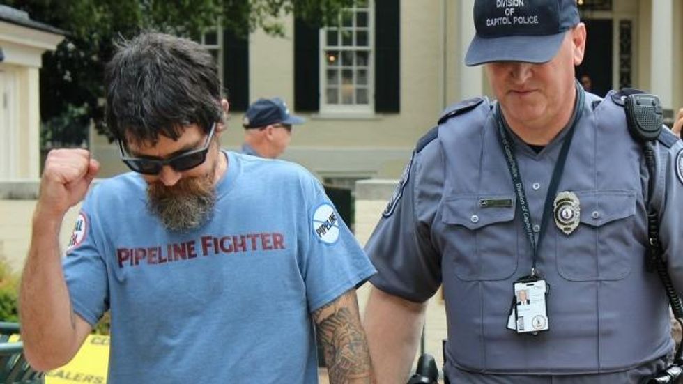 Russell Chisholm, a US Army veteran who served in Desert Storm, being arrested on Wednesday. (Photo: CCAN)