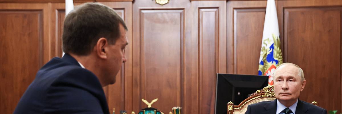 Russia's President Vladimir Putin sits at a table with Yevgeny Balitsky, the Moscow-installed head of the Zaporizhzhia region of Ukraine.