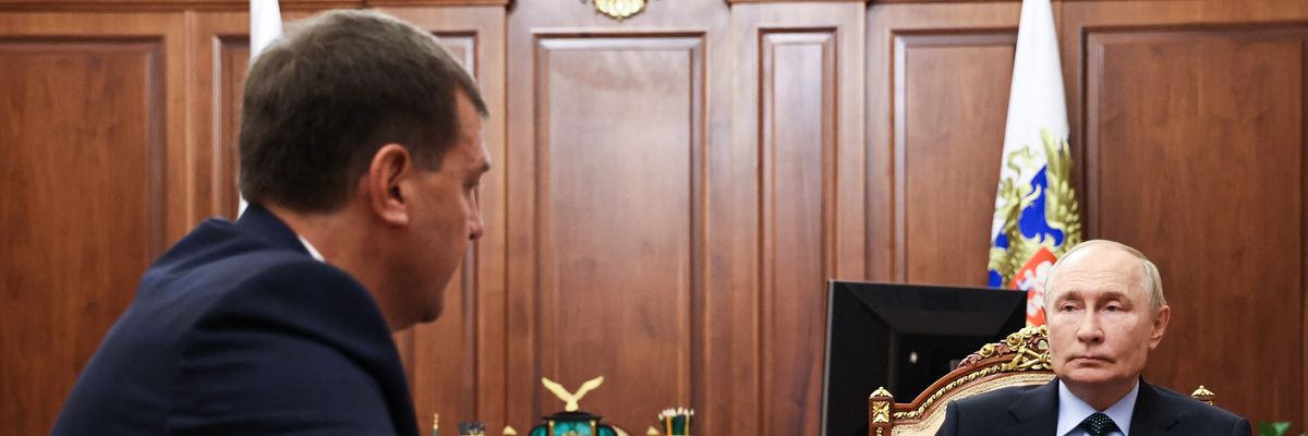 Russia's President Vladimir Putin sits at a table with Yevgeny Balitsky, the Moscow-installed head of the Zaporizhzhia region of Ukraine.