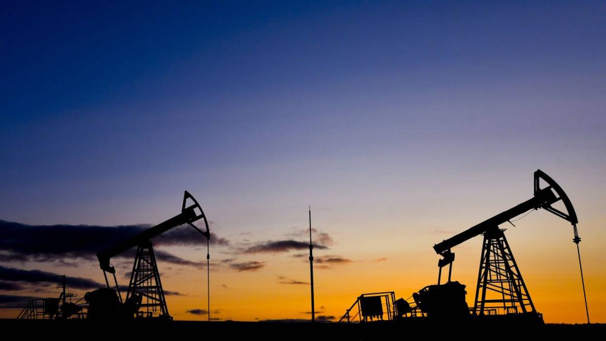 Russian oil machinery against a sunset.