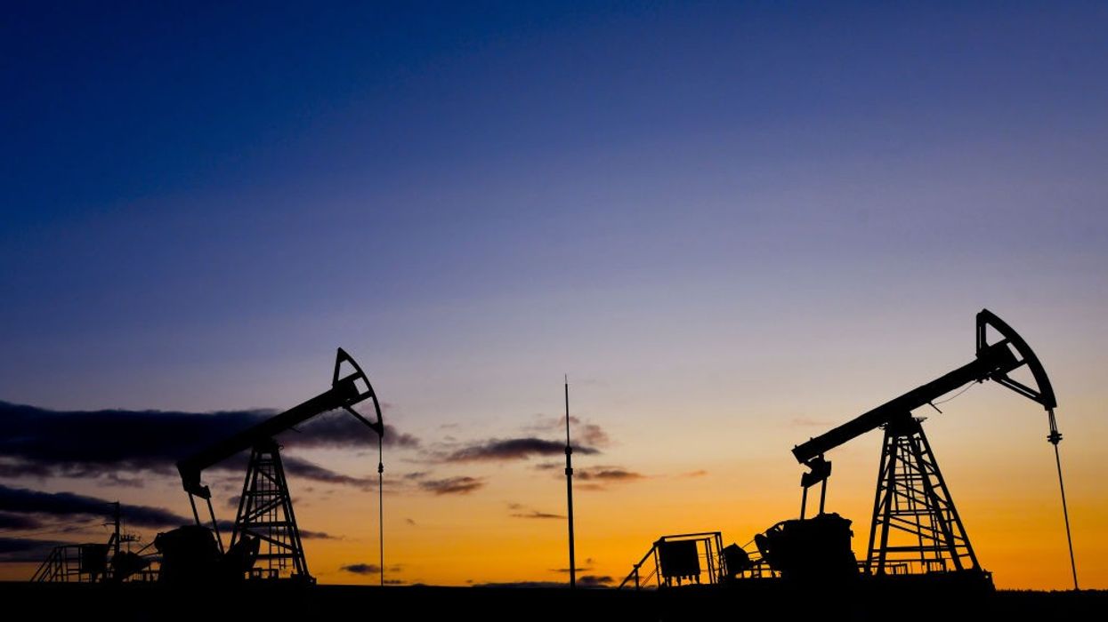 Russian oil machinery against a sunset.