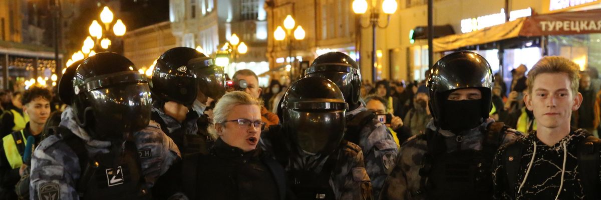 Russian police officers detain a protester during an unsanctioned anti-war demonstration at Arbat street in Moscow on September 21, 2022.