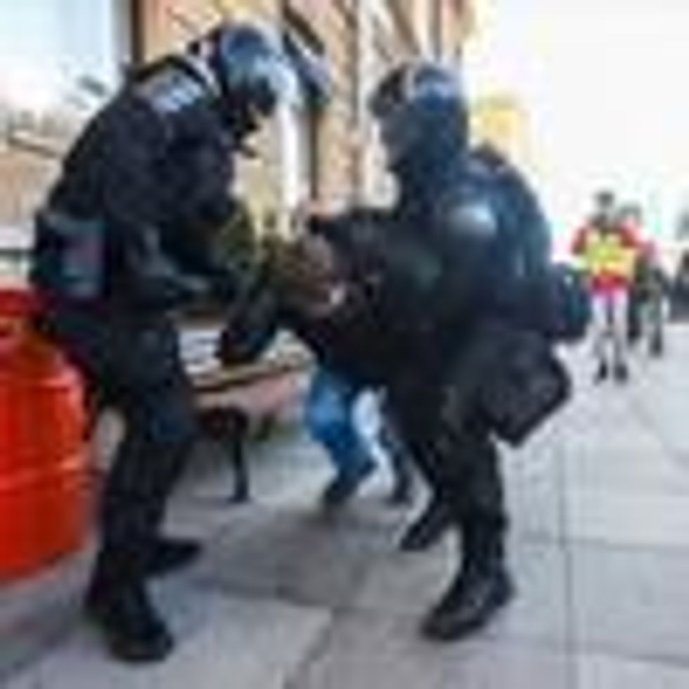 Russian police officers detain a protester