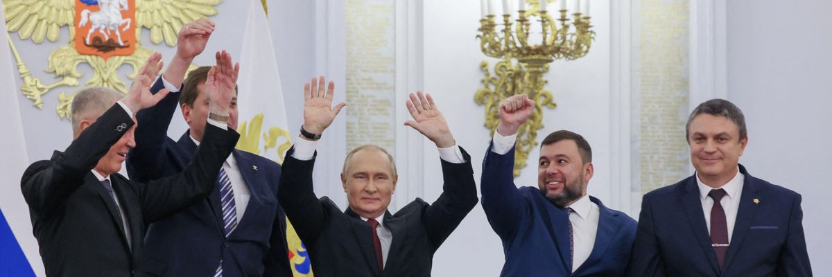 Russian President Vladimir Putin surrounded by other Kremlin officials and leaders of Donbas separatist groups