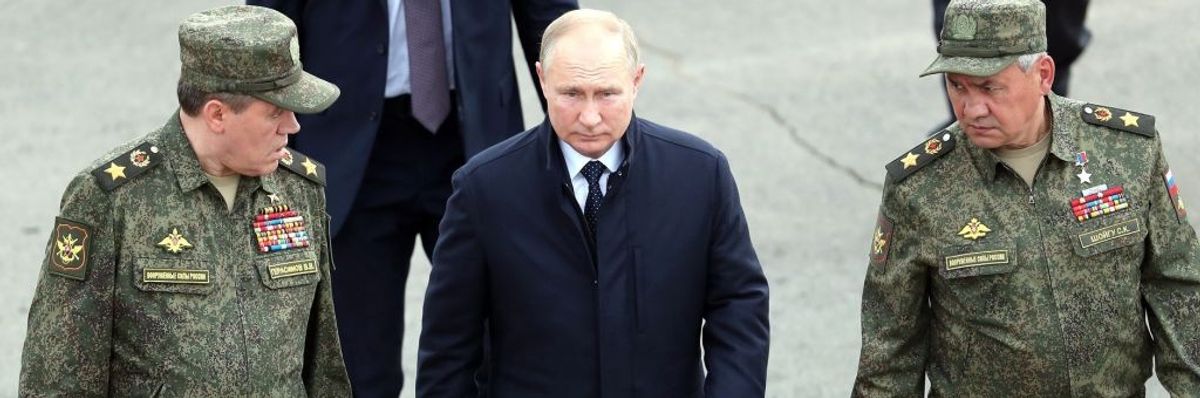 Russian President Vladimir Putin walks with his defense minister, Sergei Shoigu, and head of his general staff, Valery Gerasimov