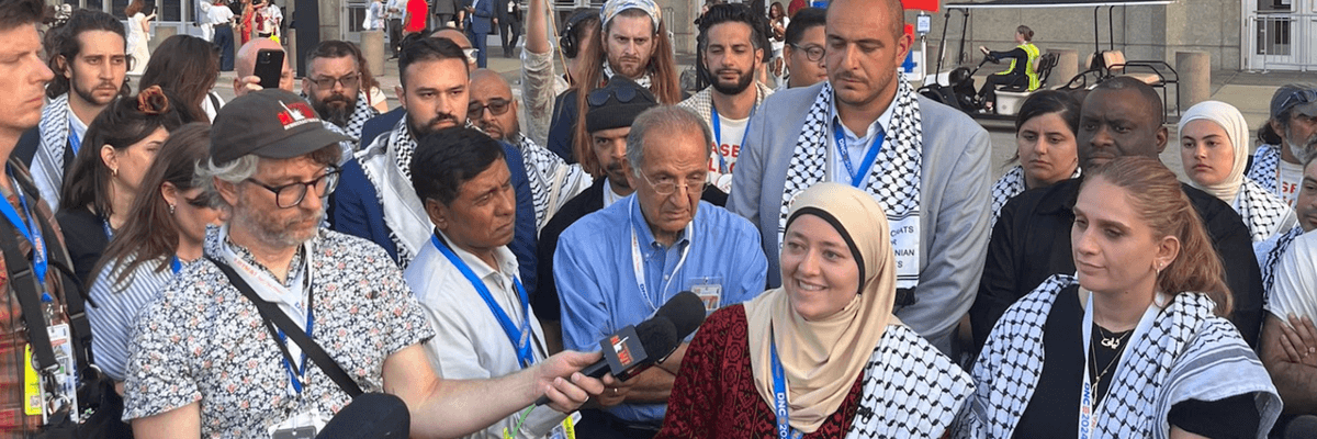 Ruwa Romman speaks surrounded by Uncommitted members