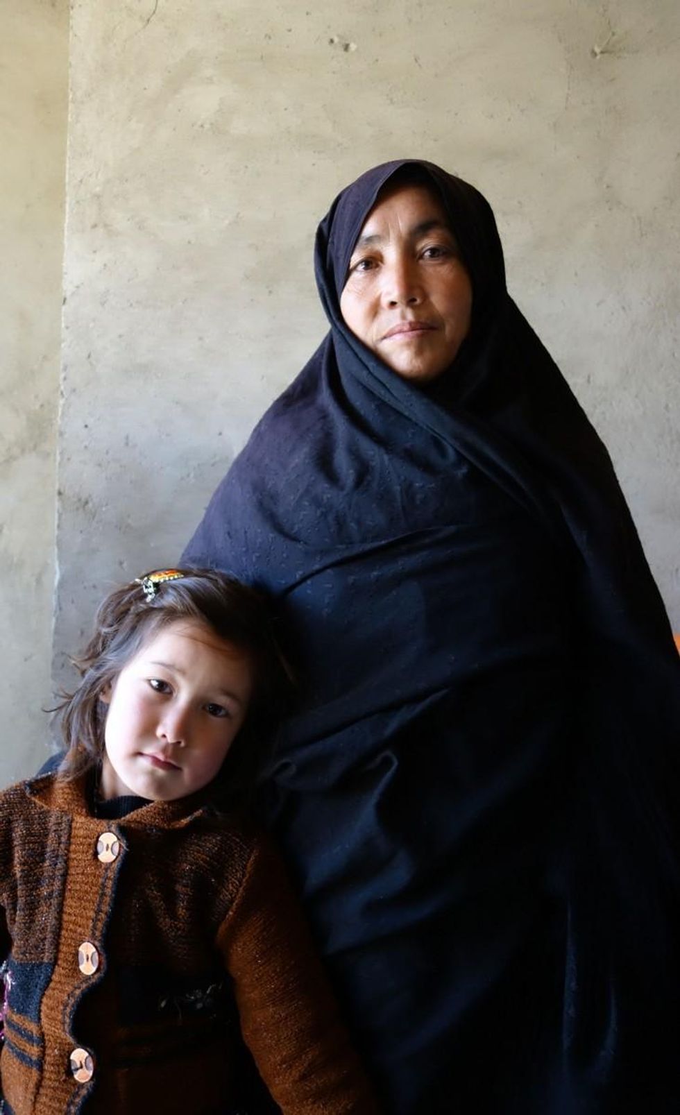 Safeh Zakira stands with her youngest daughter, age 5.