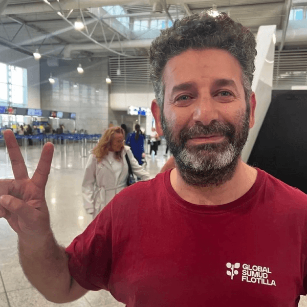 Said Abu Keshek flashes a peace sign in Athens airport