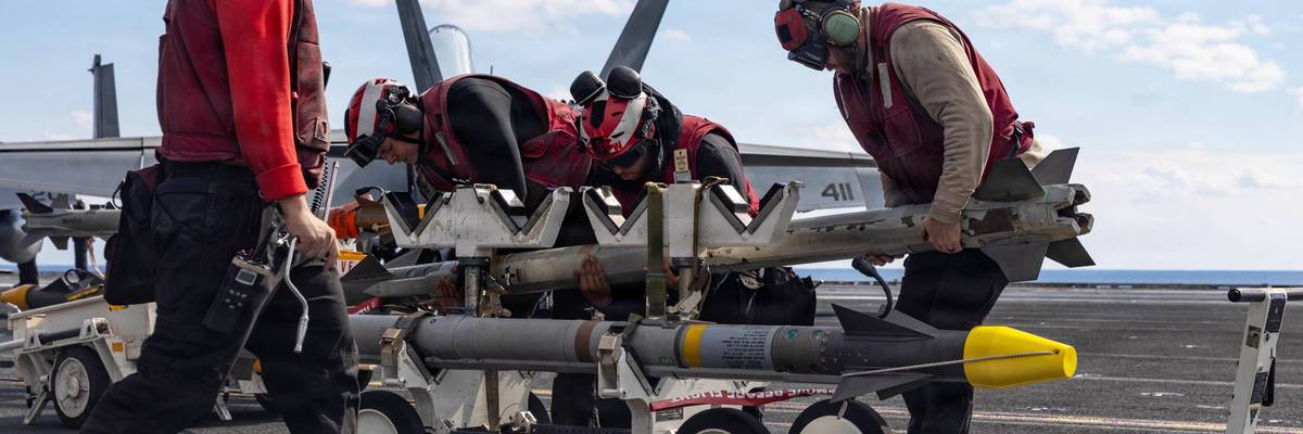 Sailors handle missiles