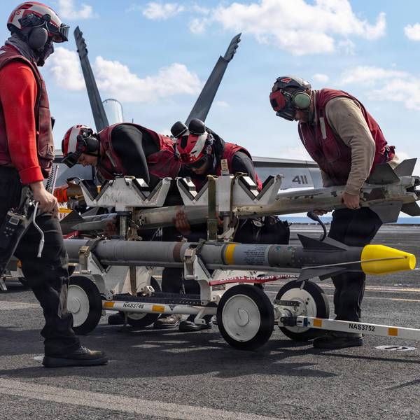 Sailors handle ordnance on the flight deck of the USS Gerald R. Ford