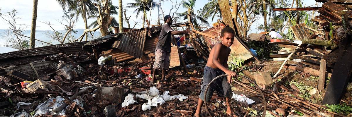 Samuel (L) and his father Phillip search through the ruins of their family home