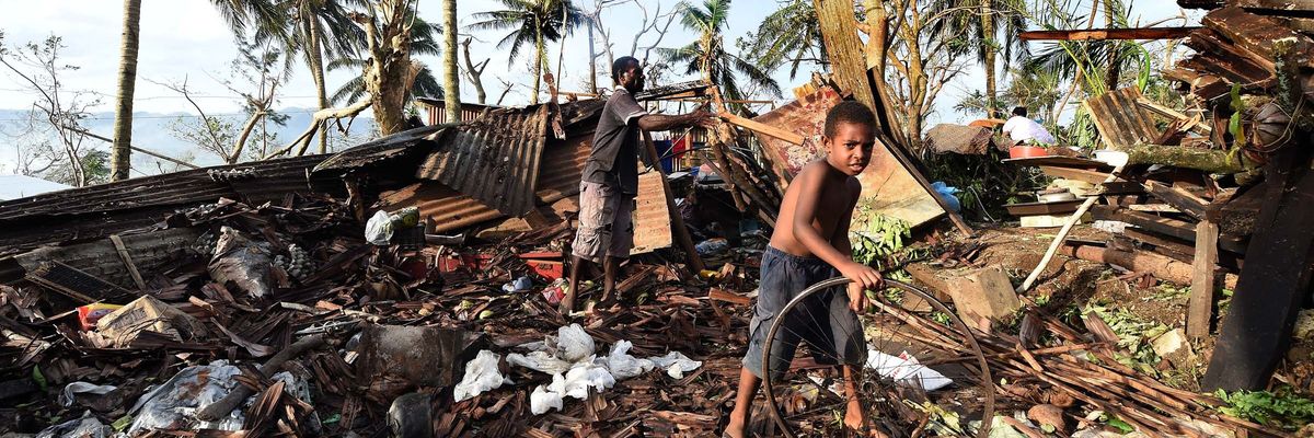 Samuel (L) and his father Phillip search through the ruins of their family home