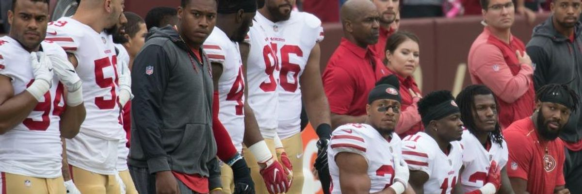 San Francisco 49ers kneel during the national anthem before a game on October 15, 2017