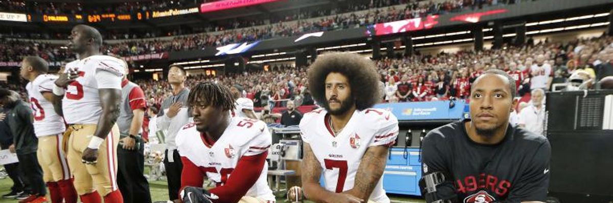 San Francisco 49ers quarterback Colin Kaepernick (7) and outside linebacker Eli Harold (58) kneel during the playing of the national anthem