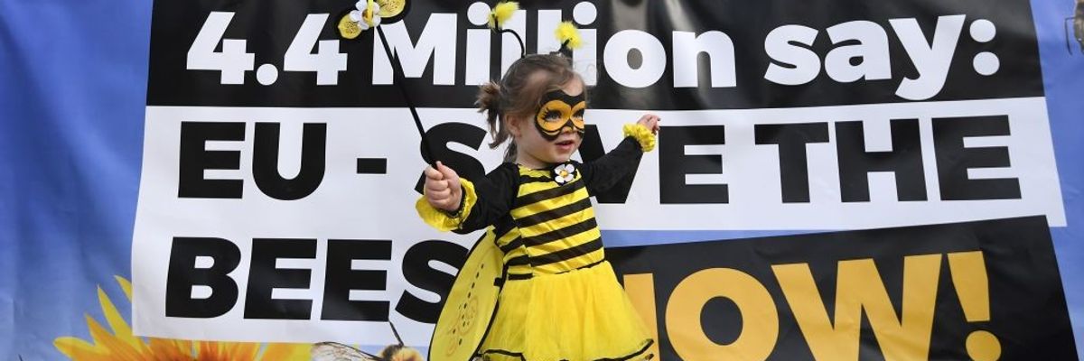 "Save the bees" protest with child dressed as a bee